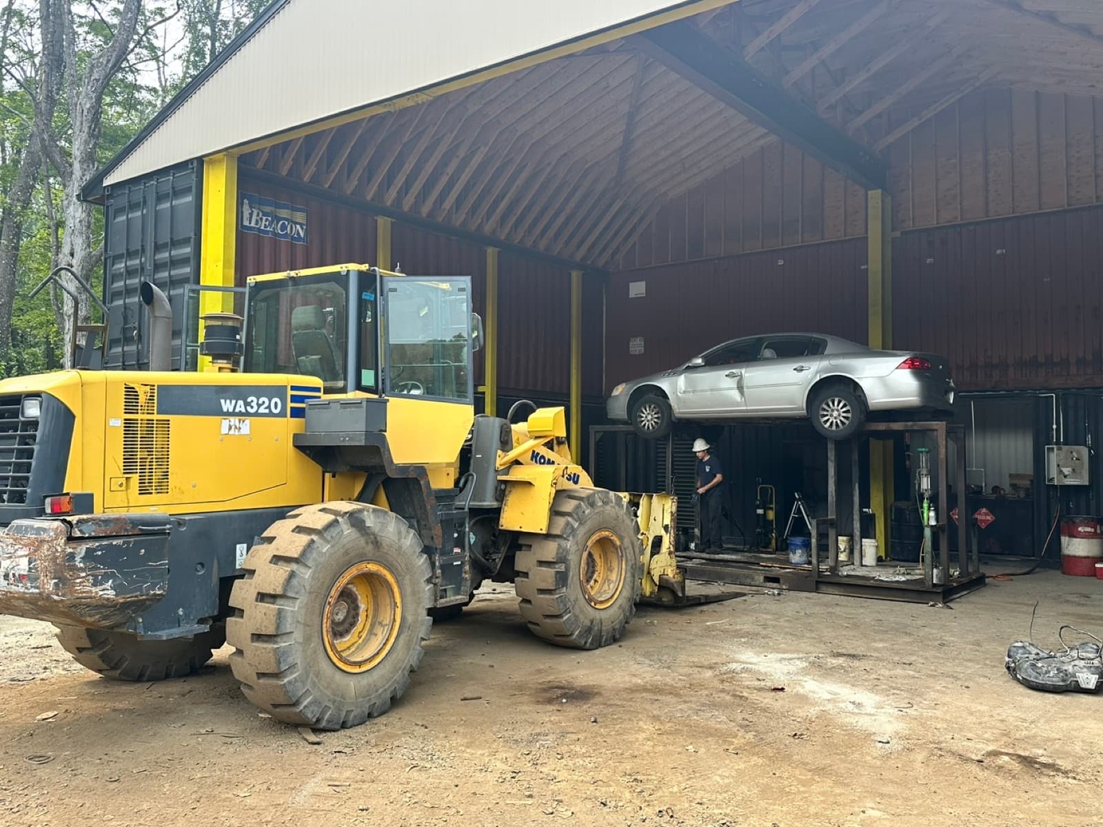 A vehicle up on the lift being stripped at the AMR yard