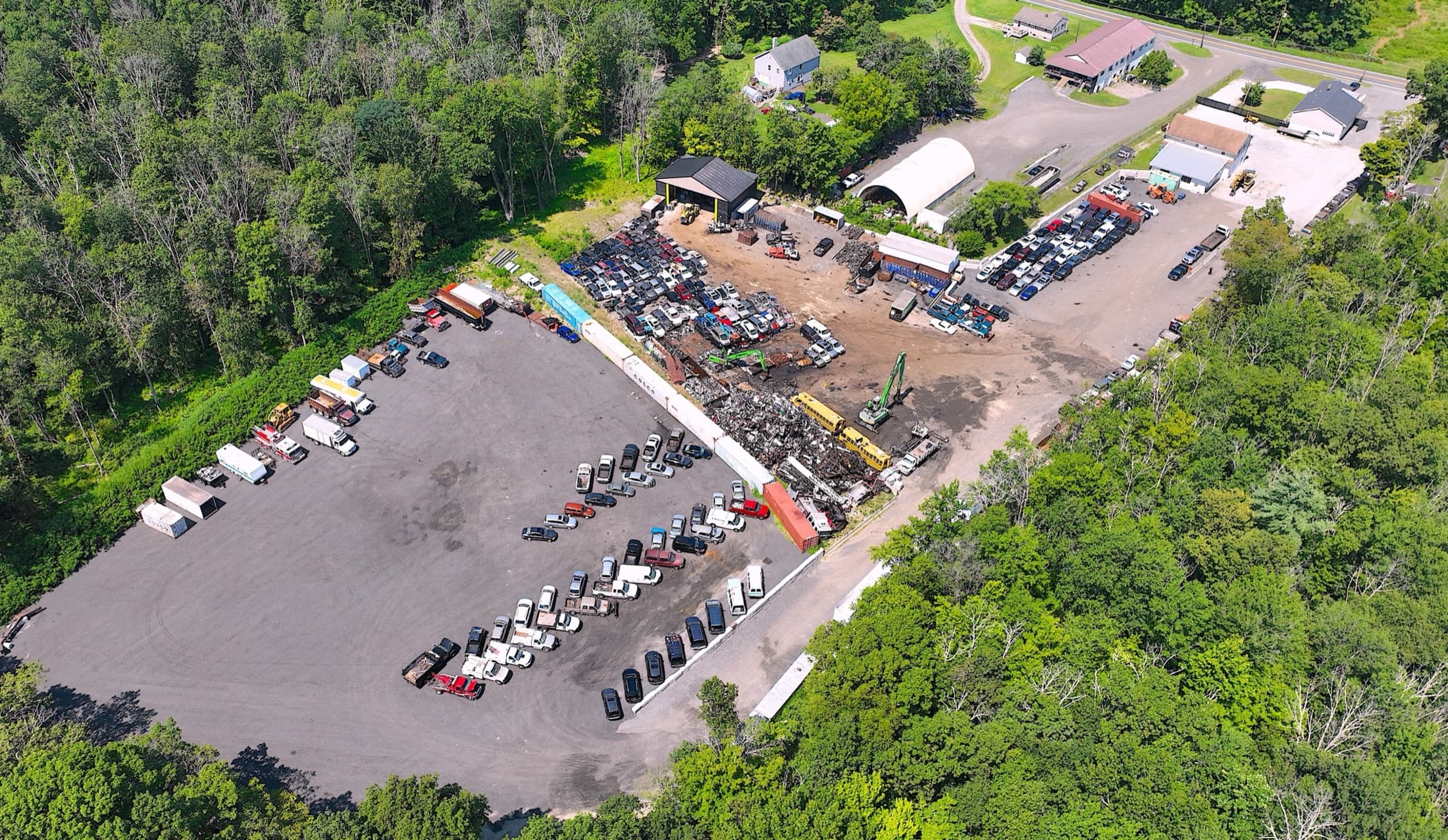 Aerial view of the Auto Metal Recycling yard surrounded by forest